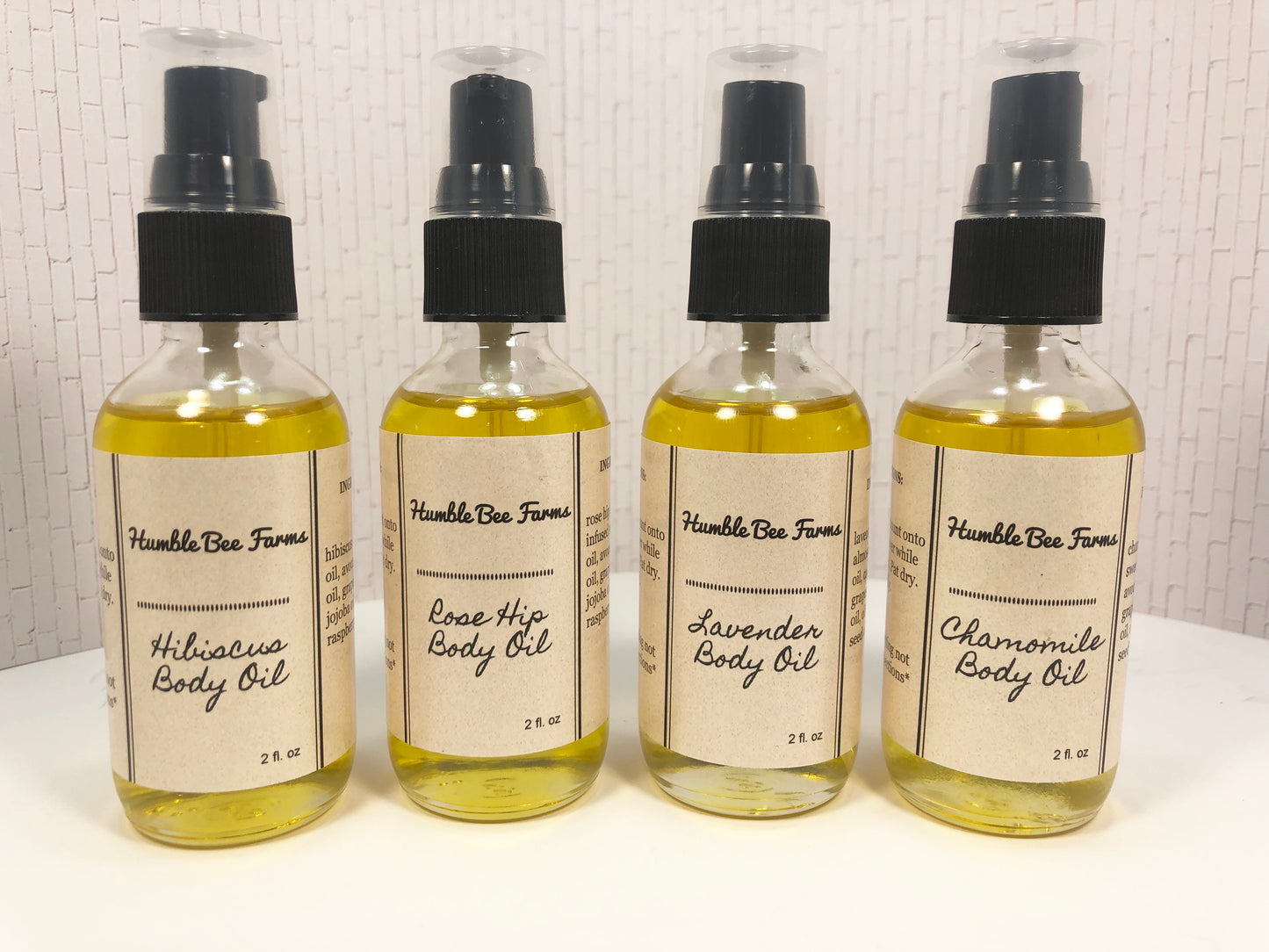 Bottles of Humble Bee Farms Herbal Body Oil.