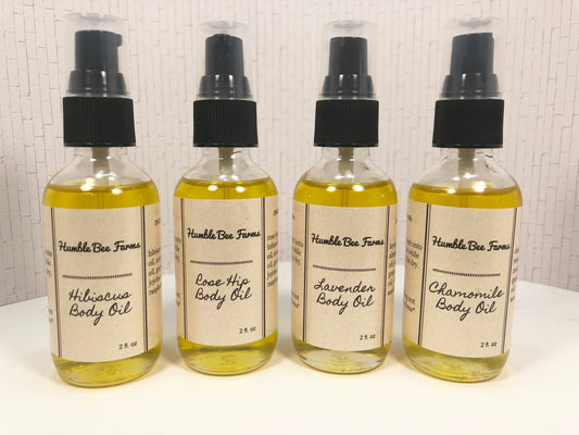 Bottles of Humble Bee Farms Herbal Body Oil.